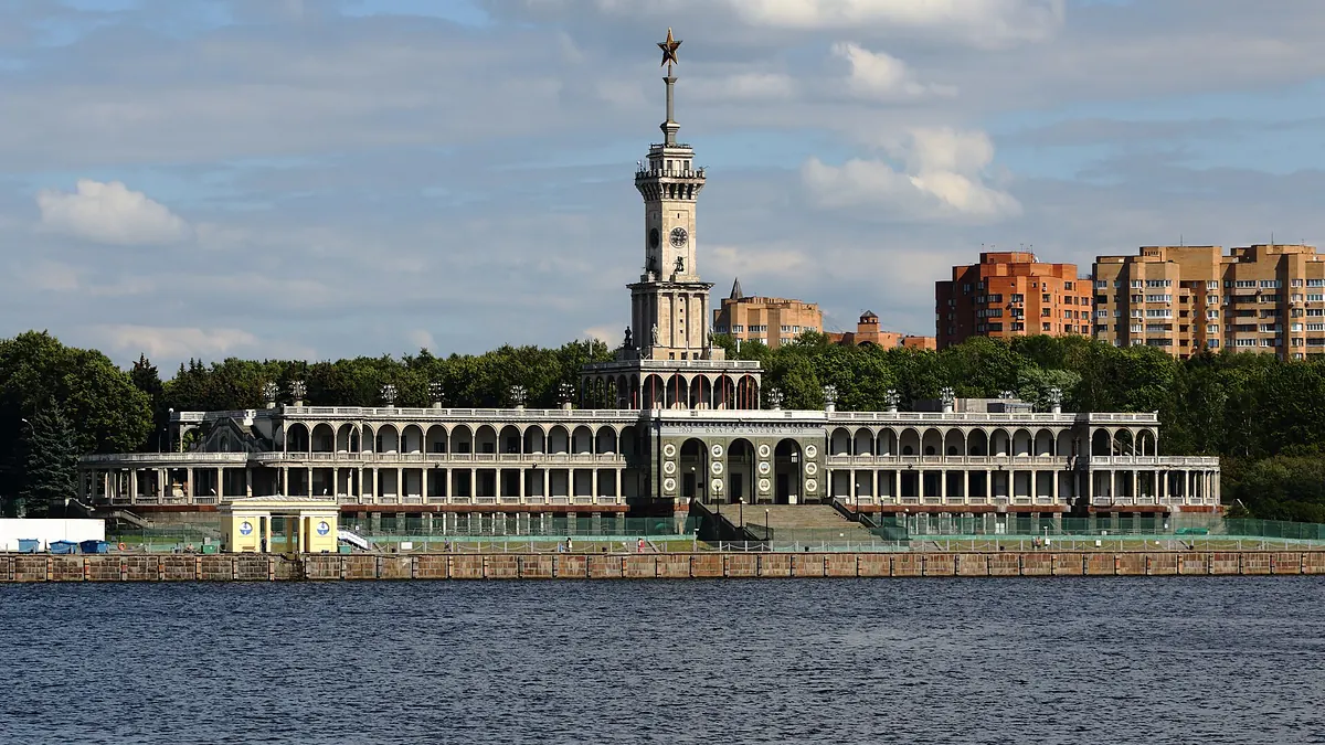 Северный речной вокзал в Москве: здание с аркадами и шпилем со звездой, вид с Химкинского водохранилища
